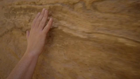 Hand touching the red rocks in Petra with Amazing  camera movement Stock Footage
