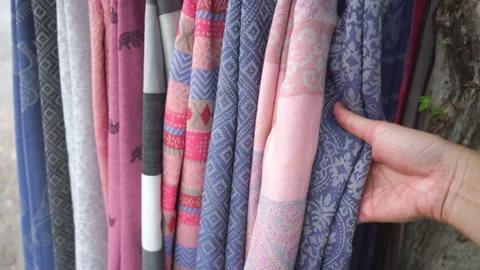 Hand touching rows of colorful traditional Thai silk fabrics, close up  Stock Footage 337073197