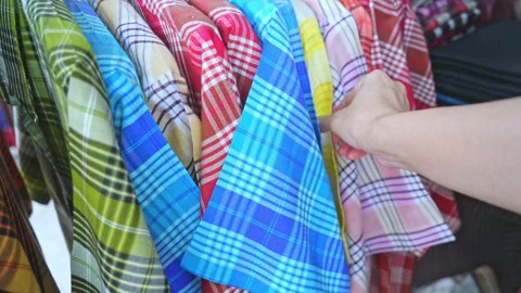 Hand touching rows of colorful traditional Thai silk fabrics, close up  Stock Footage 337073601