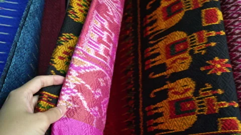 Hand touching rows of colorful traditional Thai silk fabrics, close up  Stock Footage 337073847