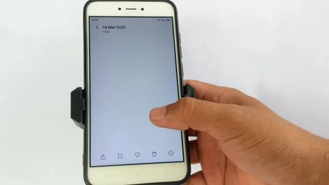 Hand touching the screen of a mobile phone placed on a holder stand Stock Footage 309460461