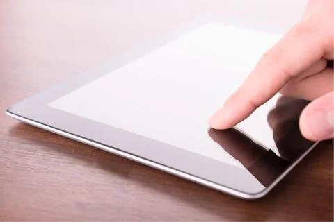 Hand touching screen on modern digital tablet pc Stock-Fotos