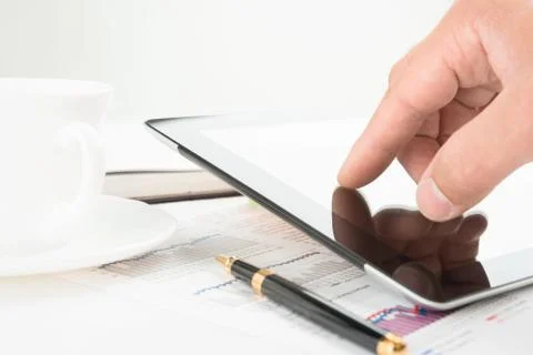 Hand touching screen of tablet pc Stock Photos