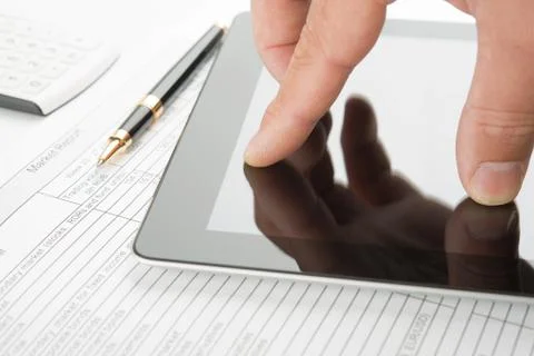 Hand touching screen of tablet pc Stock Photos