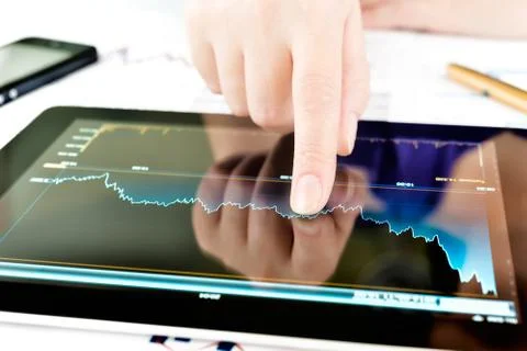 Hand touching screen of tablet pc Stock Photos