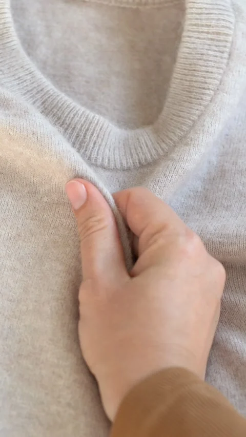 Hand touching soft woolen textile emphasizing comfort and tactile quality Stock Footage 332904886