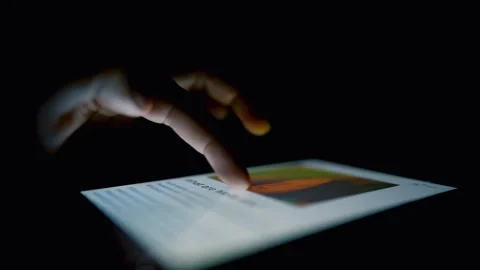 Hand Touching Tablet Screen in Dark Room Stock Footage 317737009