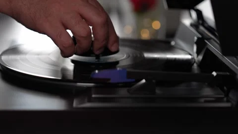Hand touching vinyl record on turntable, analog music lifestyle concept Stock Footage 333311493