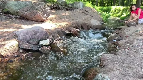 Hand touching water in the forest river or lake Stock Footage 143530738