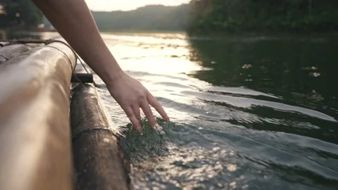 Hand touching water in the forest river or lake enjoying nature Stock Footage 229244867