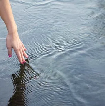 Hand touching water Stock Photos