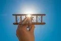 The hand with a toy plane on the background of the clear sky Photo