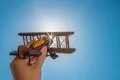 The hand with a toy plane on the background of the clear sky Photo
