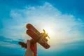 The hand with a toy plane on the background of the sunset Photo