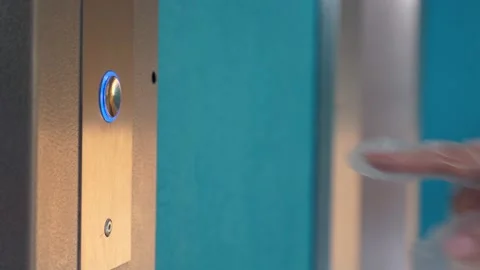 Hand in a transparent glove presses the elevator button. Personal protection Stock Footage 140458026