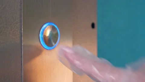 Hand in a transparent glove pushing the elevator button. Personal protection Stock Footage 141447177