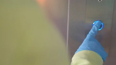 Hand in a transparent glove pushing the elevator button. Personal protection Stock Footage 142486755