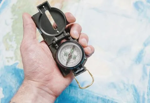 Hand with travel compass. Stock Photos