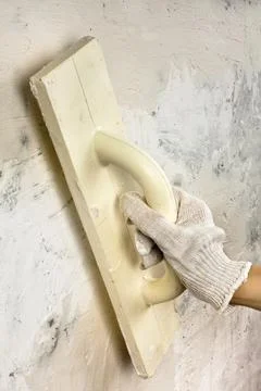 Hand with trowel plastering wall Stock Photos