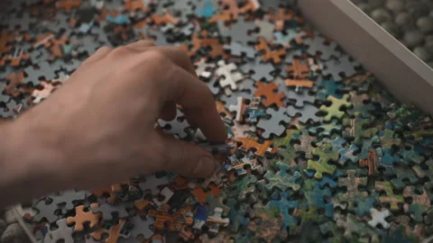 Hand trying find the missing piece to a puzzle Stock Footage 132138005