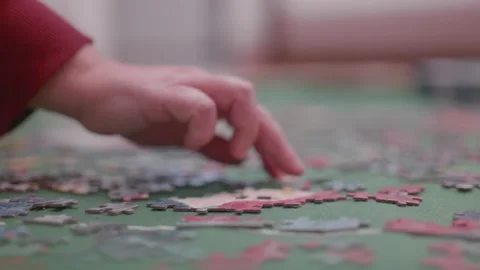 Hand trying to make a puzzle Stock Footage 302738350