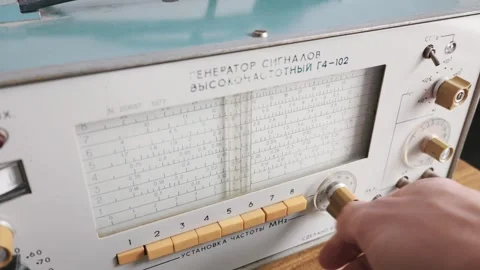 Hand Tuning an Old Soviet-Era High-Frequency Radio Signal Generator Stock Footage 334116486