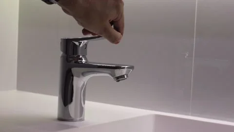 Hand of turn open or off the faucet Stock Footage 158276096