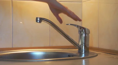 Hand turn on stream of water flows from the tap Stock Footage 48390164