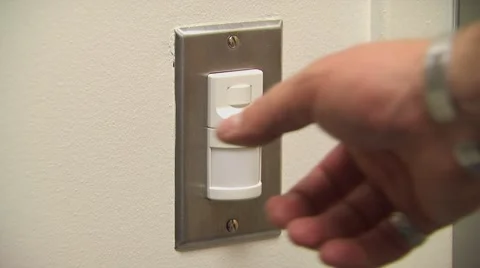 A hand turning on and off a light switch Stock Footage 54593000