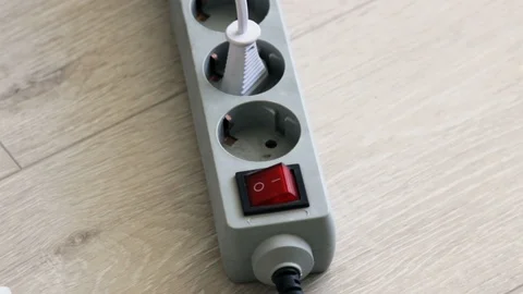 Hand Turning On And Turning Off The Power Cord Extension Block Surge Protector. Stock Footage 128228829