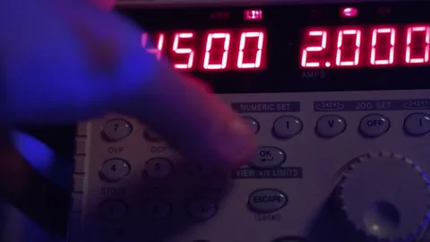 Hand turning on and using an oscilloscope, a measurement tool in a laboratory Stock Footage 210225626