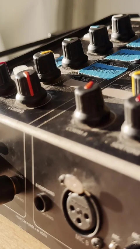 Hand turning an audio intercom knob up on a control panel with XLR socket Stockbeeldmateriaal 337231314