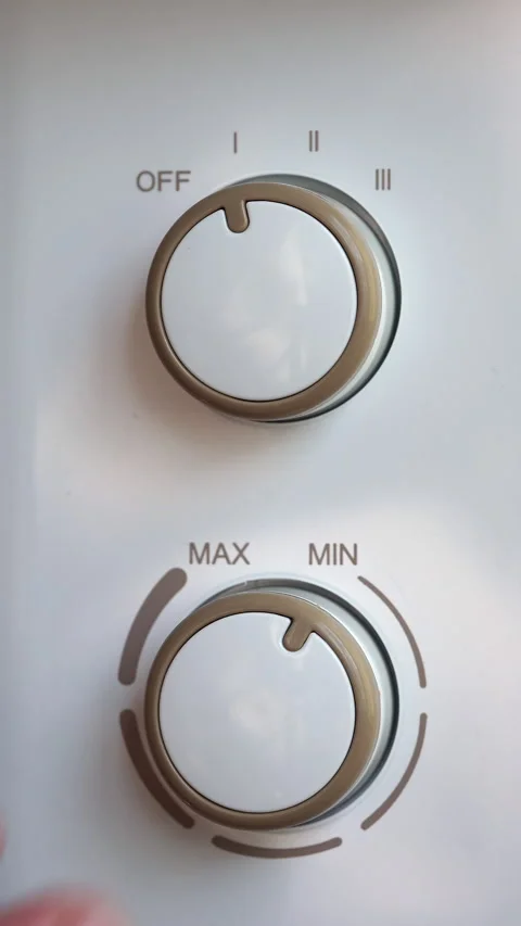 Hand Turning Both Mode And Temperature Knobs On Electric Oil Heater Radiator. Ve 스톡 동영상 285942997
