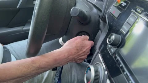 Hand turning car ignition key to start engine close up Stock Footage 340583094