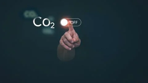 Hand turning off co2 switch in digital environment Stock Photos