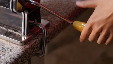Hand turning the crank of the pasta machine Stock Footage 97943440