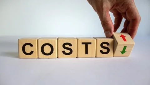 Hand is turning a cube and changes the direction of an arrow symbolizing that Stock Photos