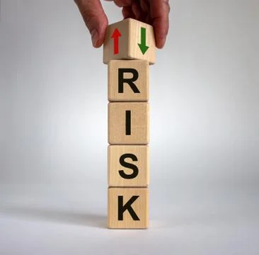 Hand is turning a cube and changes the direction of an arrow symbolizing that Stock Photos