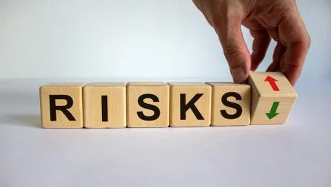 Hand is turning a cube and changes the direction of an arrow symbolizing that Stock Photos