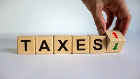 Hand is turning a cube and changes the direction of an arrow symbolizing that Stock Photos