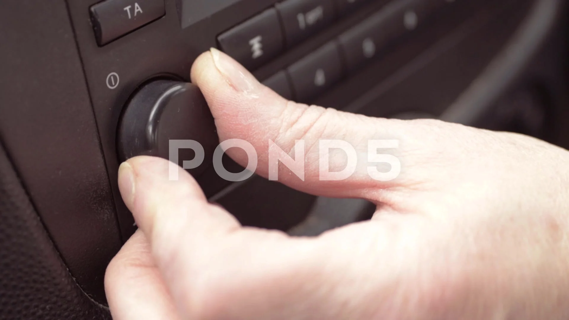 Hand turning dials on a car radio close ... | Stock Video | Pond5