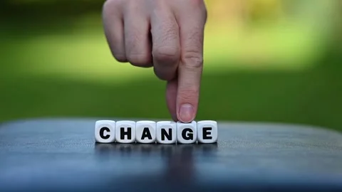 Hand is turning a dice and changes the word change to chance. Stock Footage 162480983