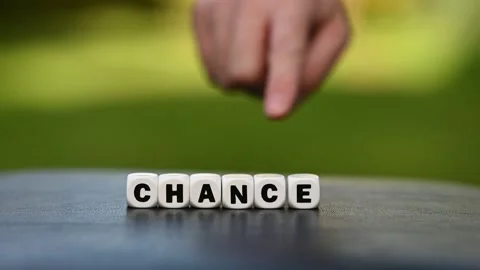 Hand is turning a dice and changes the word chance to change. Stock Footage 162481269