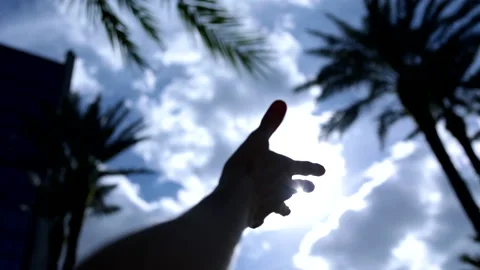 Hand turning in front of sun Video stock 176562005