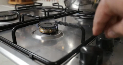 Hand turning gas knobs to light a gas oven. 스톡 동영상 234015663