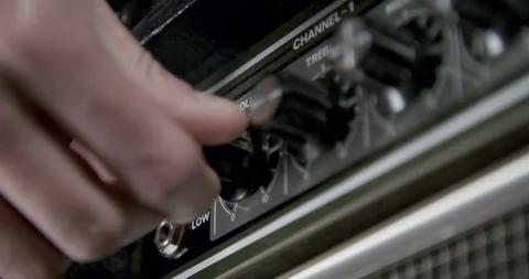 Hand turning guitar amplifier knobs Stock Footage 102039332
