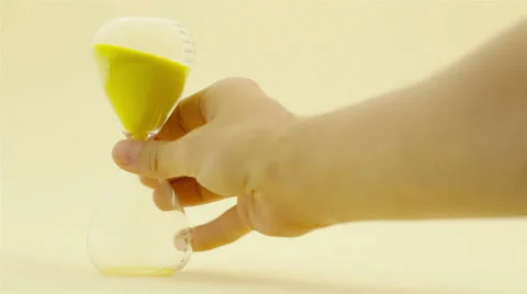 Hand turning hourglass Stock Footage 32328254