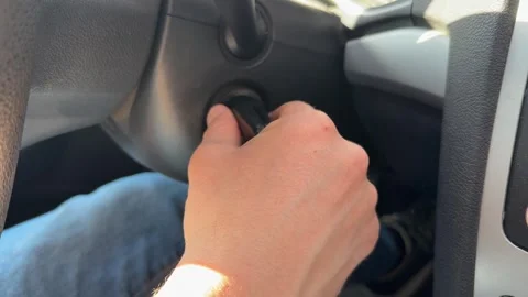 Hand turning ignition key to start car engine, vehicle startup and traditional Stock Footage 337120799