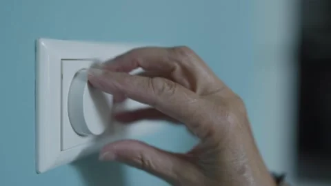 Hand Turning Light Switch on and off as Symbol of Energy Saving Stock Footage 316806144
