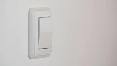 Hand turning on a light switch Stock Footage 88387141